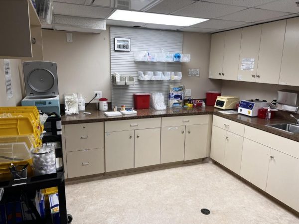 Clinical research center biochemestry analyzer room designed for clinical trial use stocked with requisite laboratory supplies in close proximity to participants.