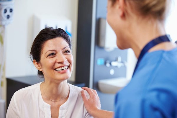 Woman talking with nurse while participating in a clinical research study.